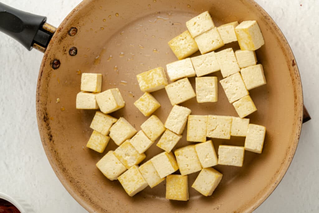 tofu being cooked in a skillet