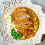 chicken katsu curry on a plate with white rice and parsley