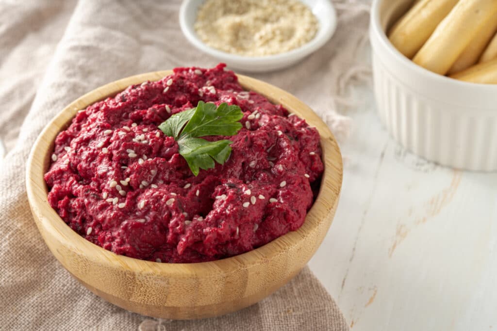 roasted beet hummus served with breadstick crackers