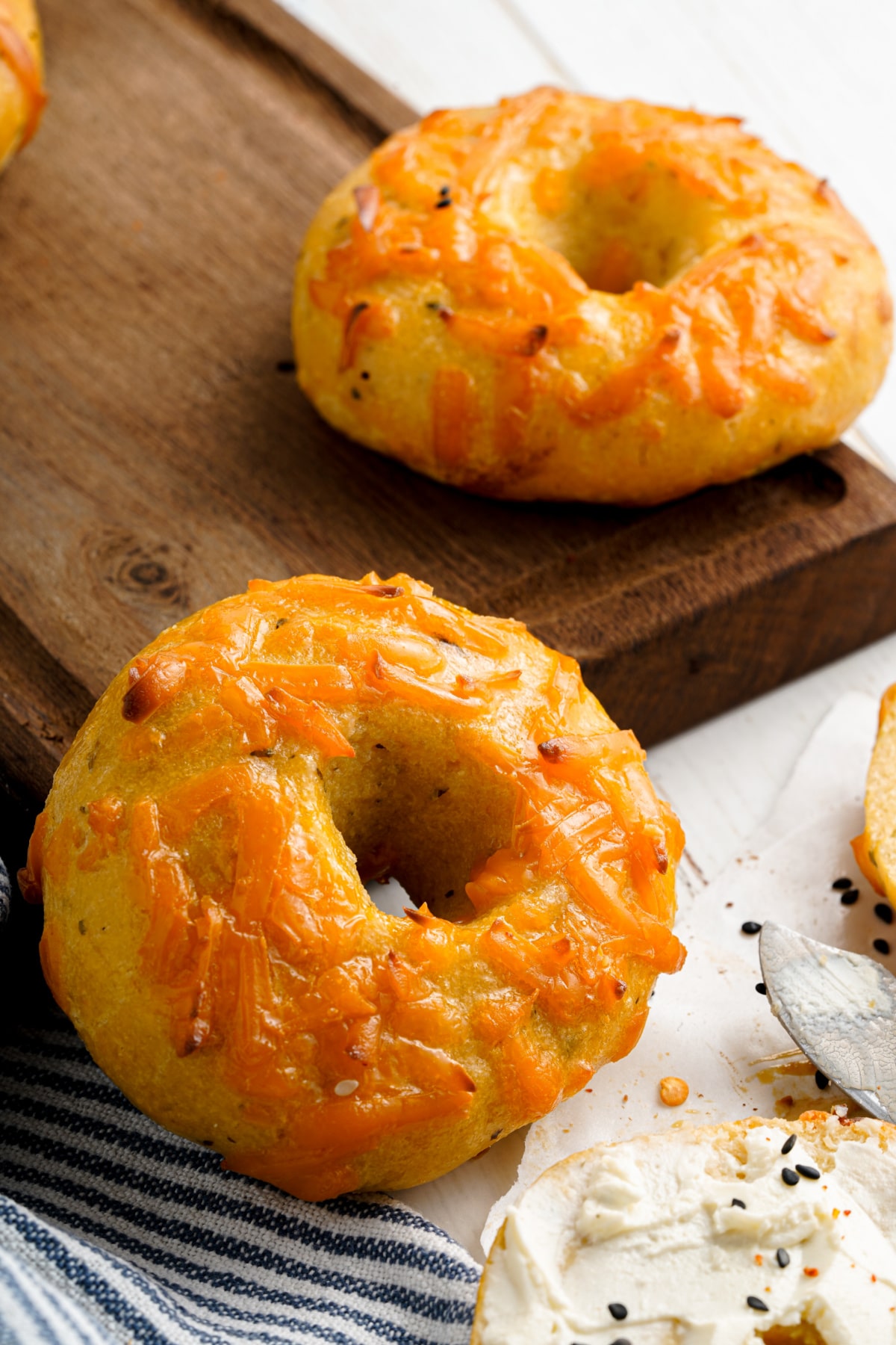 keto bagels recipe with cheddar cheese topping and cream cheese spread