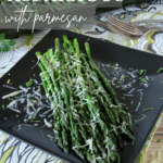 roasted asparagus with parmesan on a black plate