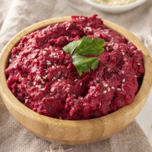 roasted beet hummus with sesame seeds as garnish