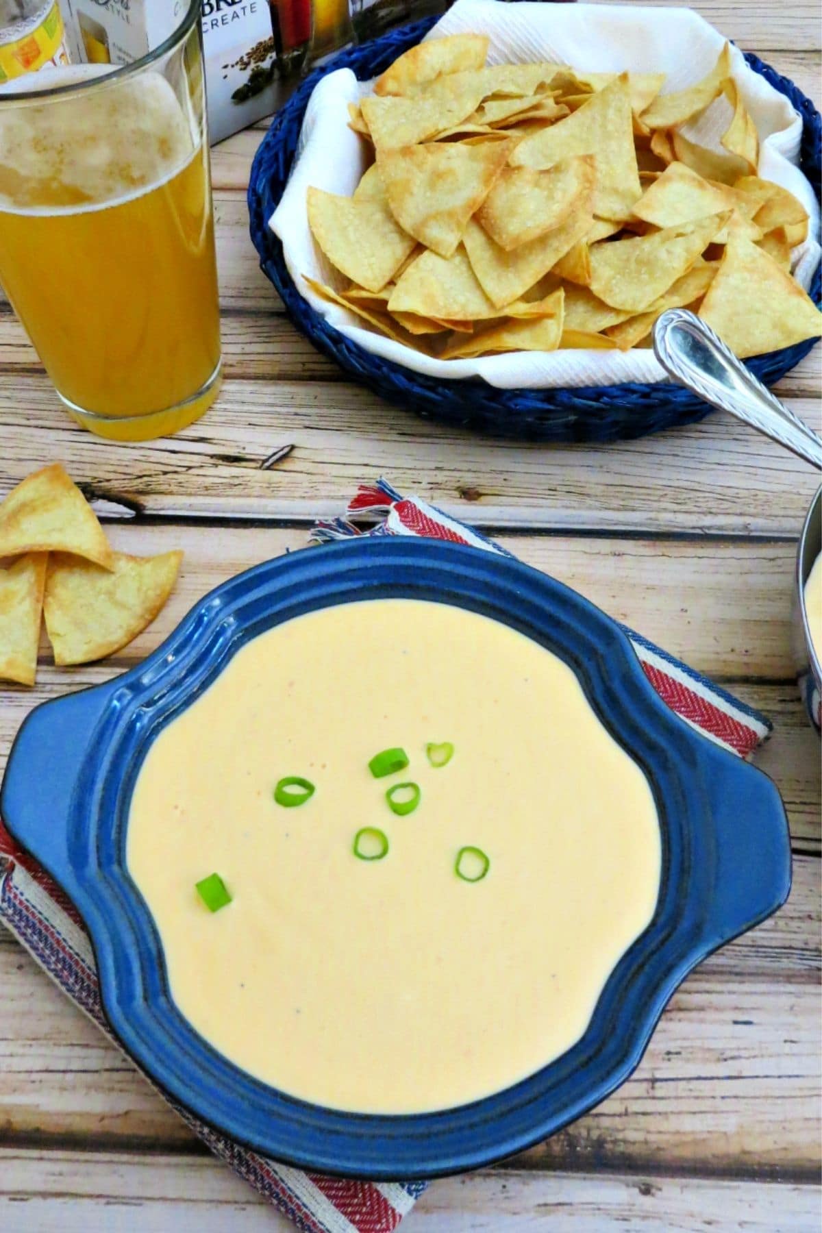 bowl of sriracha beer cheese dip with sliced green onions