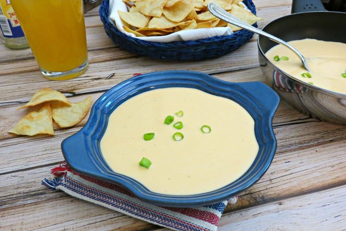 beer cheese dip in a blue bowl and skillet