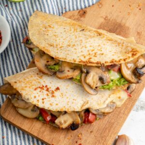 cheese and mushroom quesadilla on a cutting board