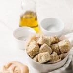 bowl of sesame tofu bites with sriracha dip