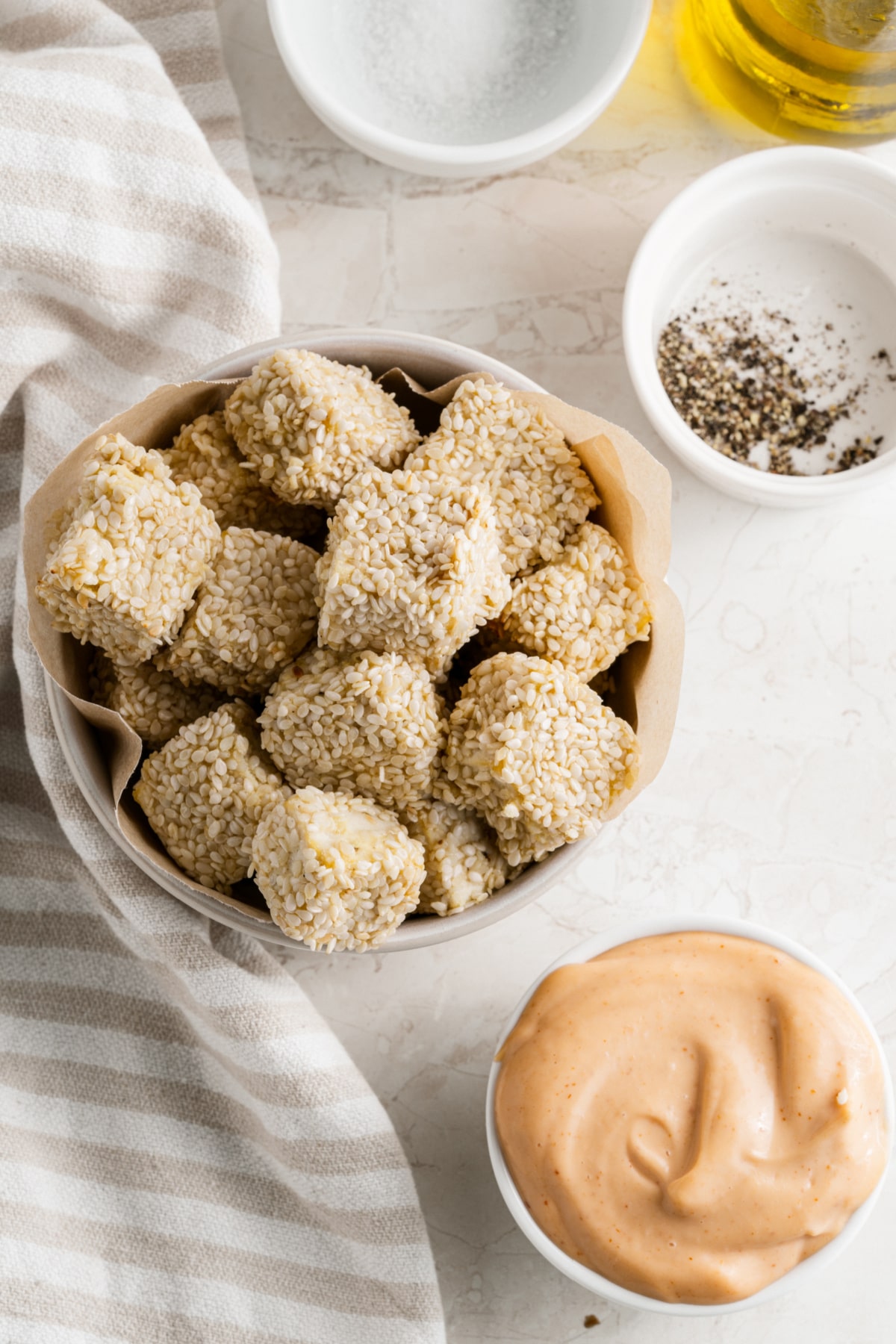 bowl of sesame baked tofu bites with sriracha mayonnaise