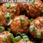 close up of pork Asian meatballs with sauce scallions and sesame seeds