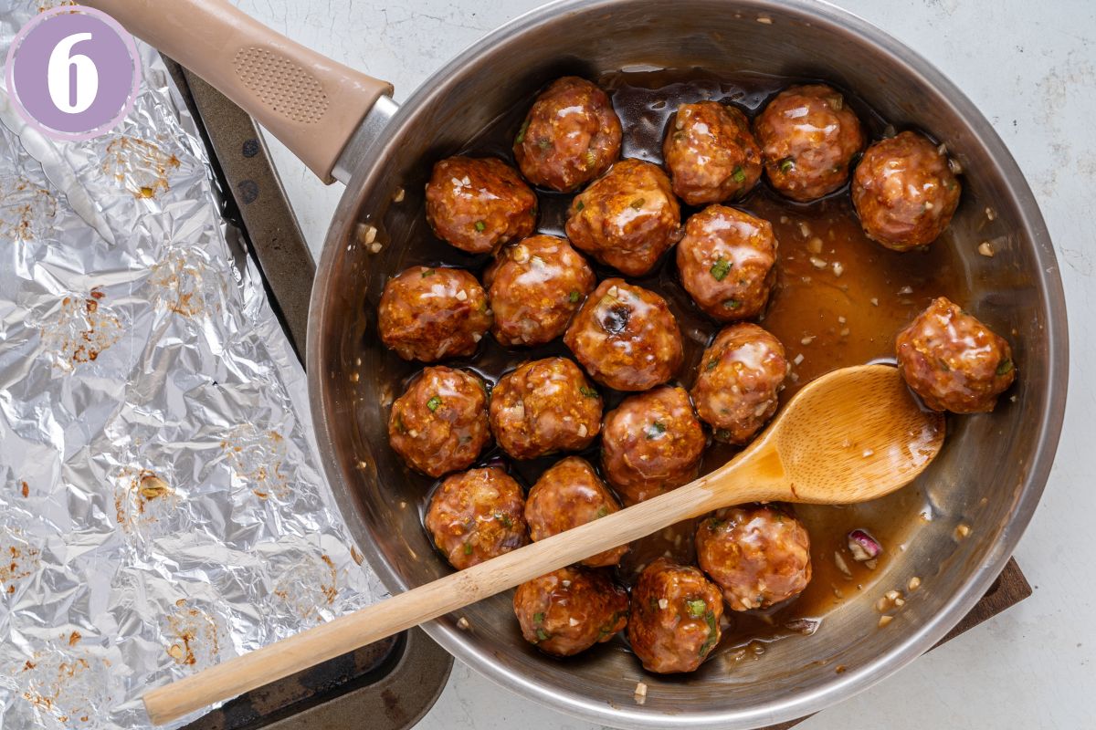 tossing the Asian meatballs with the sauce