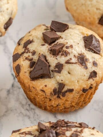 vegan muffins with chocolate chips on a white marble background